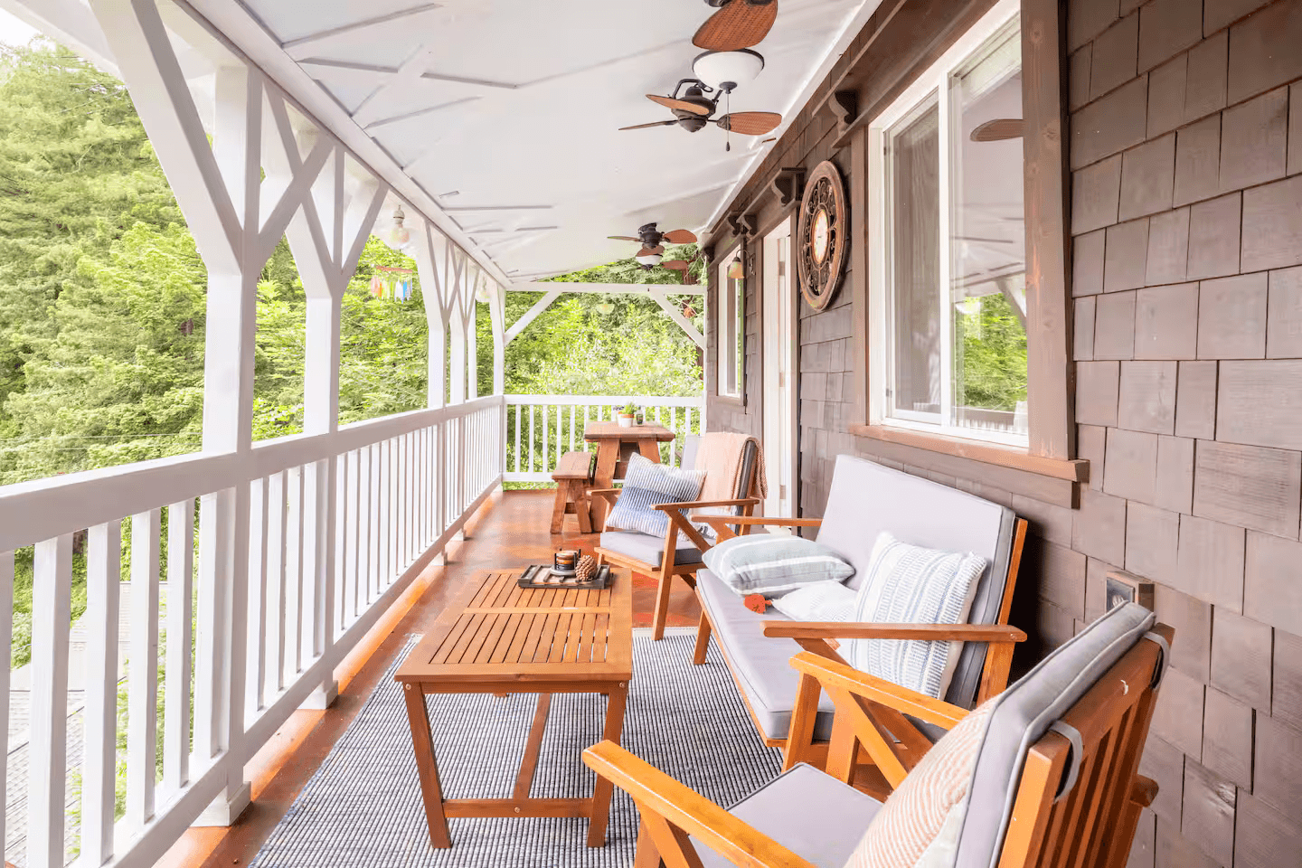 Covered porch at River Roost in Forestville, surrounded by redwoods